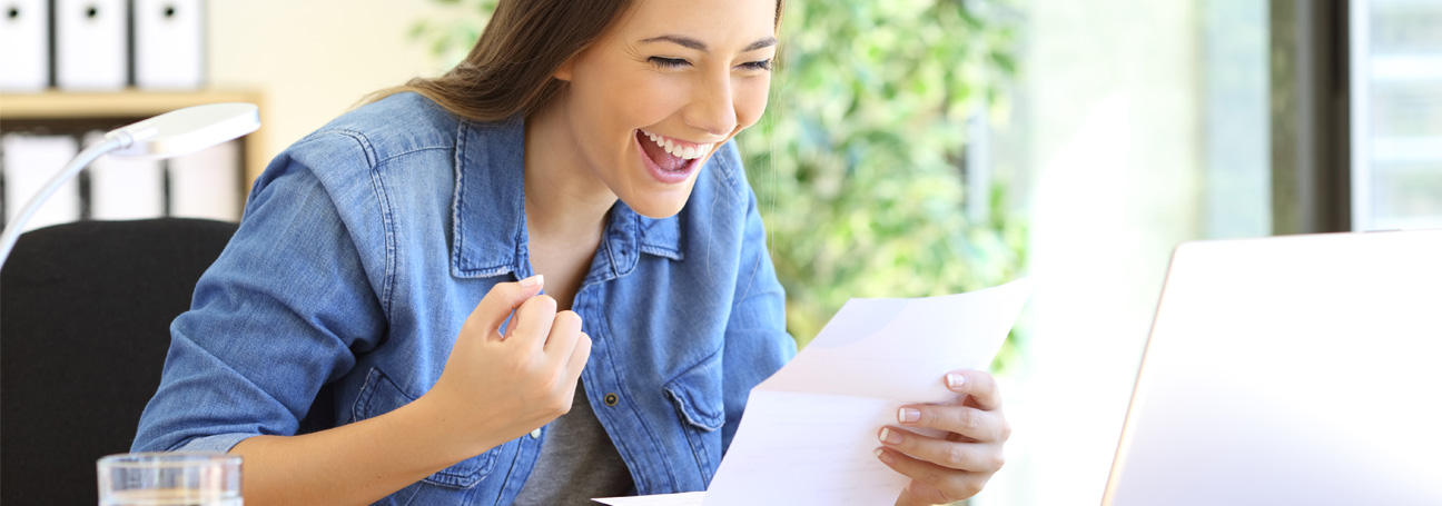 Excited woman reads letter approved for cash advance on structured settlement