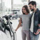 Young couple buying a car with cash