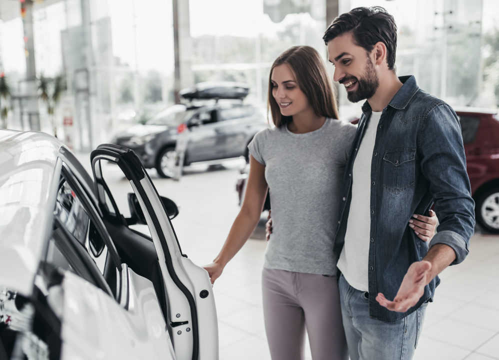 Young couple buying a car with cash