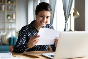 smiling woman looks over payment options for medical bills