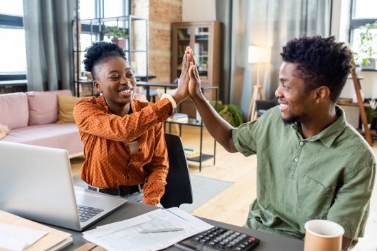 high-five successful business partners