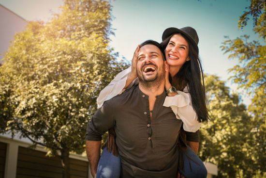 A happy couple outdoors, embracing financial freedom after cashing out their annuity for a lump sum payment.