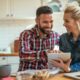Smiling couple reviewing annuity cash-out options on a tablet at home.