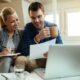 Couple exploring structured settlement cash-out options online.