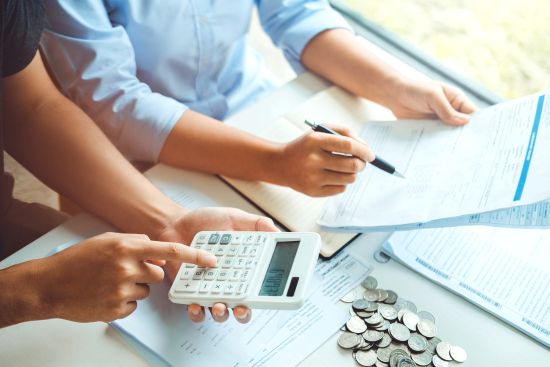 Serious couple discussing paperwork at home, reviewing their lump sum settlement option for future planning