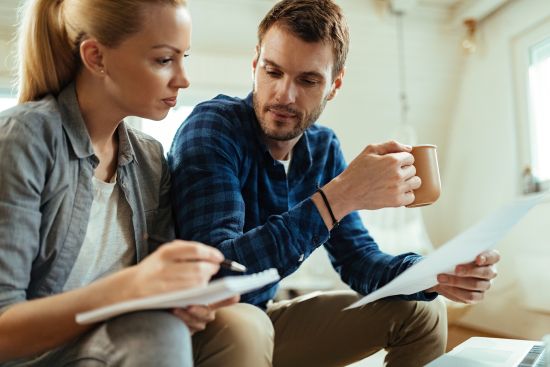 Couple sitting at home reviewing paperwork and considering different annuity payment options.