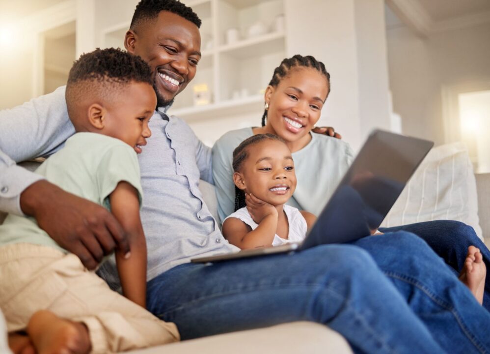 Family smiling while exploring structured settlement buyout options online