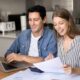 young couple reviewing investment documents after selling annuity payments for lump sum cash