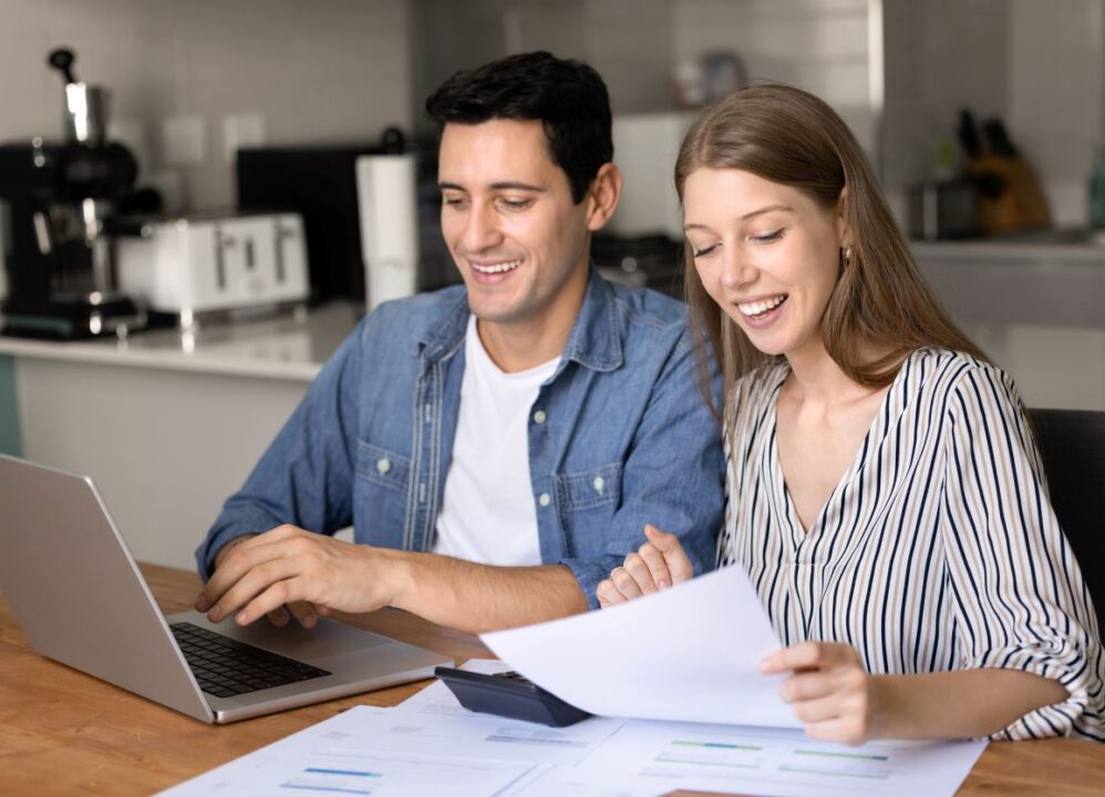 young couple reviewing investment documents after selling annuity payments for lump sum cash
