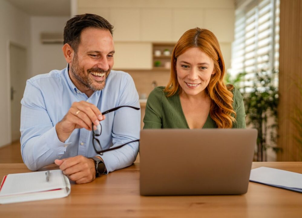 couple discussing financial options and selling structured settlement payments online for immediate cash